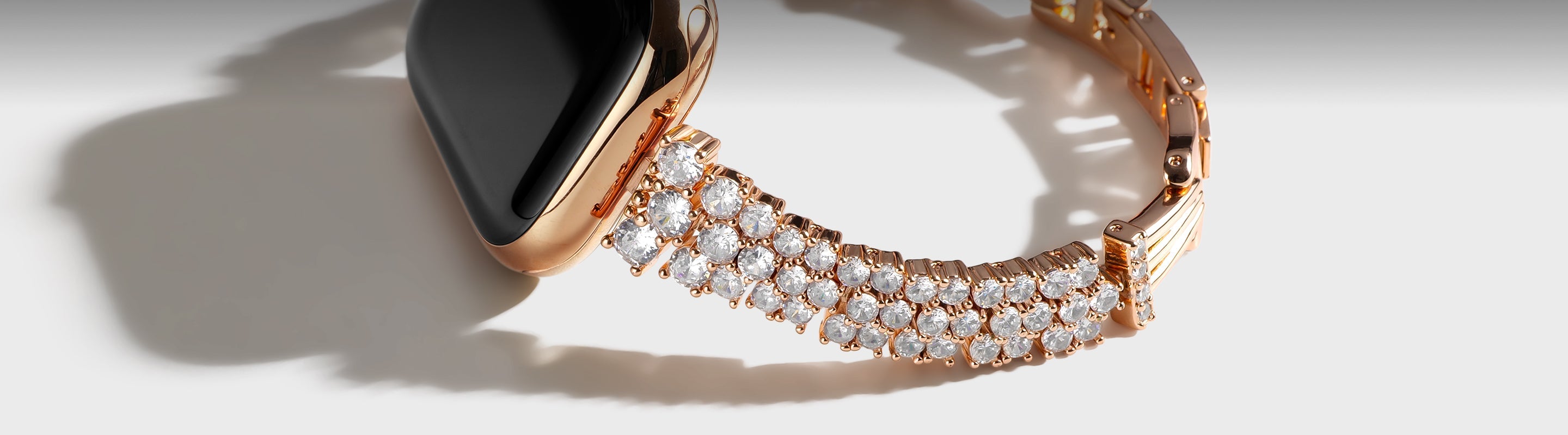 there is a rose-golg Apple watch band with pearl jewelry
