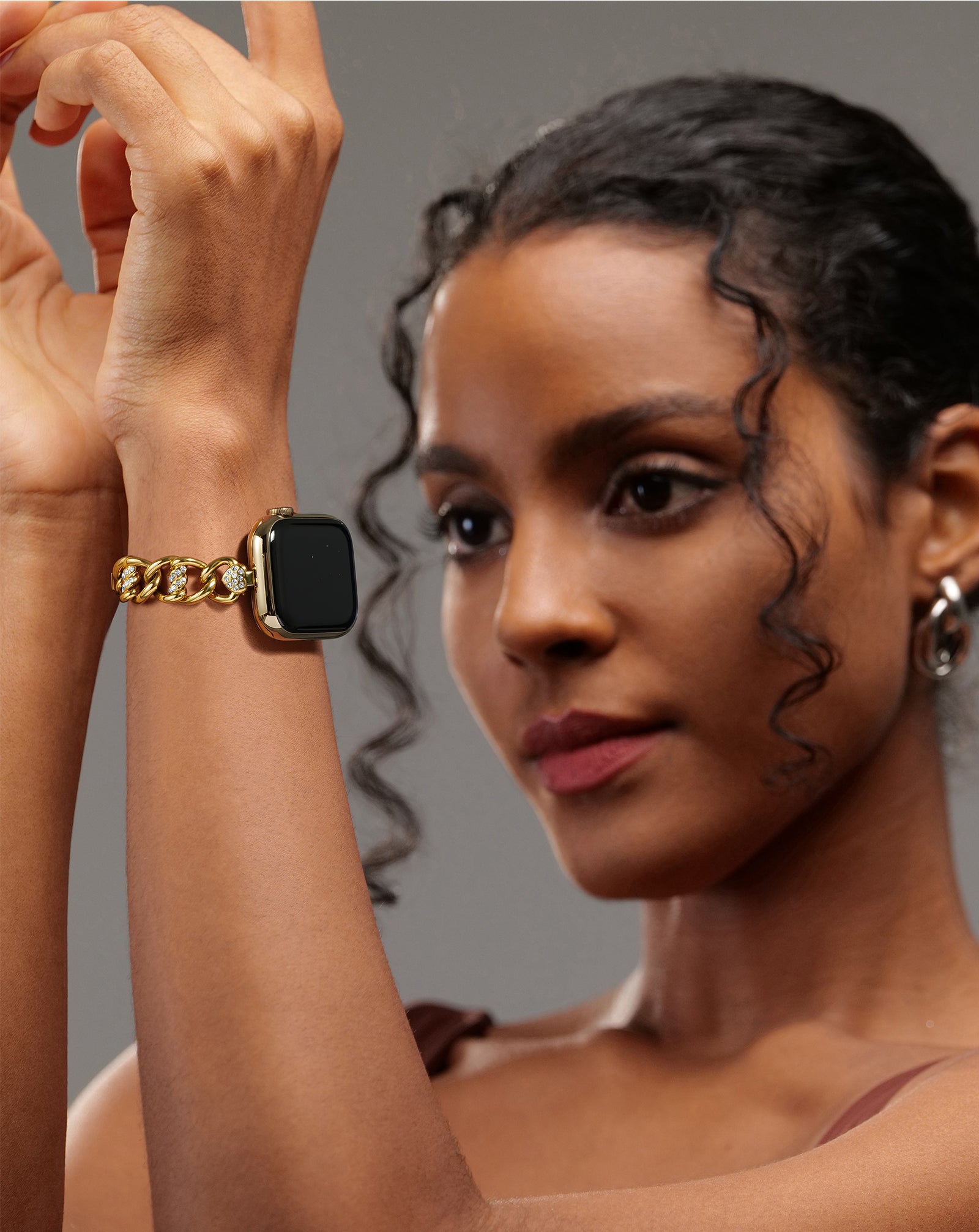 Model wearing the LUXIMAL Heart-Woven Gold Pavé Apple Watch strap, styled with an elegant outfit for a refined jewelry look.