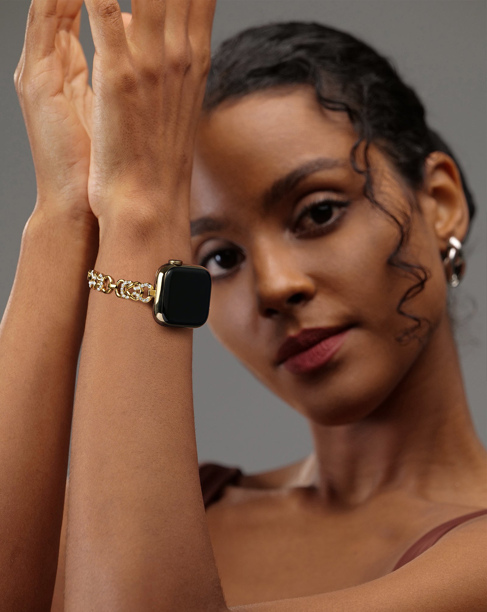 Model wearing the LUXIMAL Gold Pavé Chain Apple Watch strap, styled with an elegant outfit for a refined jewelry look.