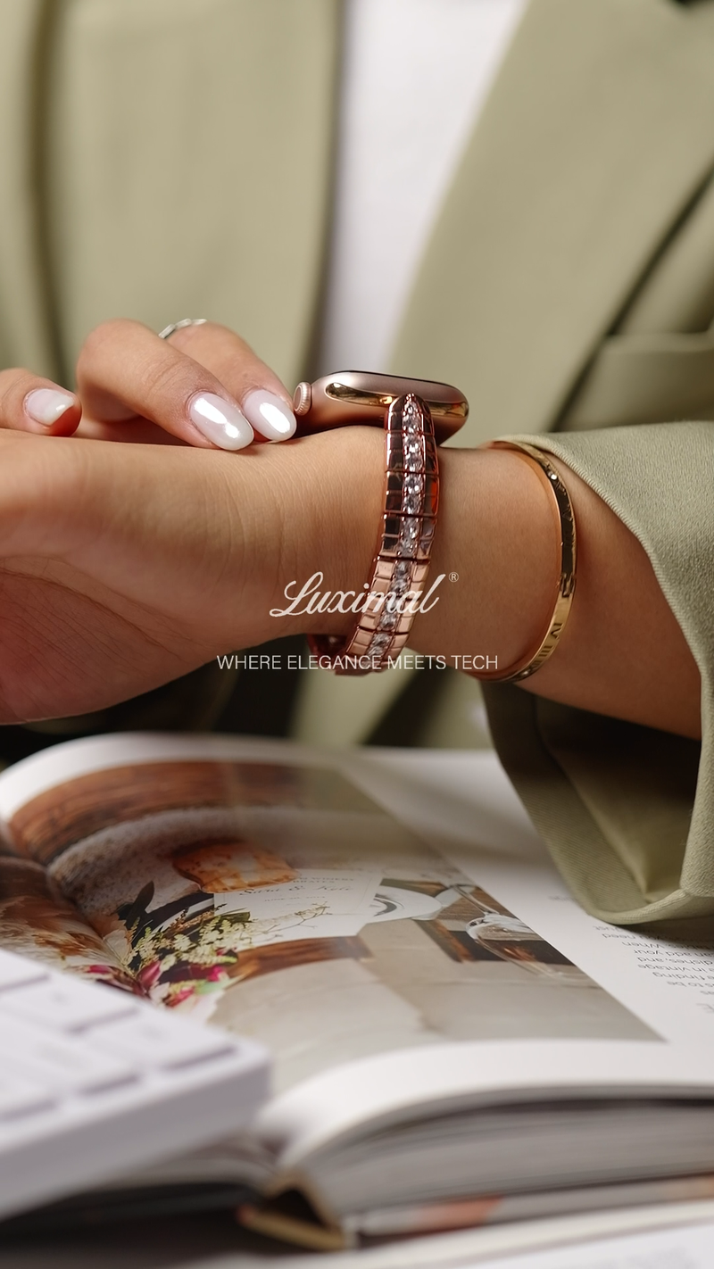 A woman in a green suit showcases the LUXIMAL Rose Gold Serpentine Grace Band, highlighting its detailed serpentine design and elegant rose-gold finish, perfect for work and everyday wear.